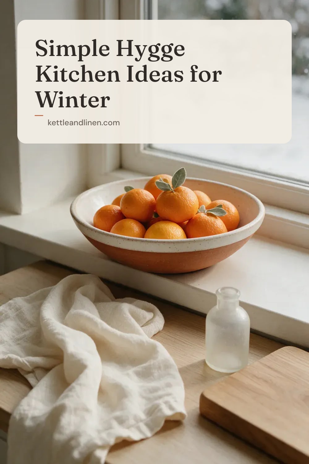 A bowl of clementines on a kitchen windowsill with a snowy garden outside.