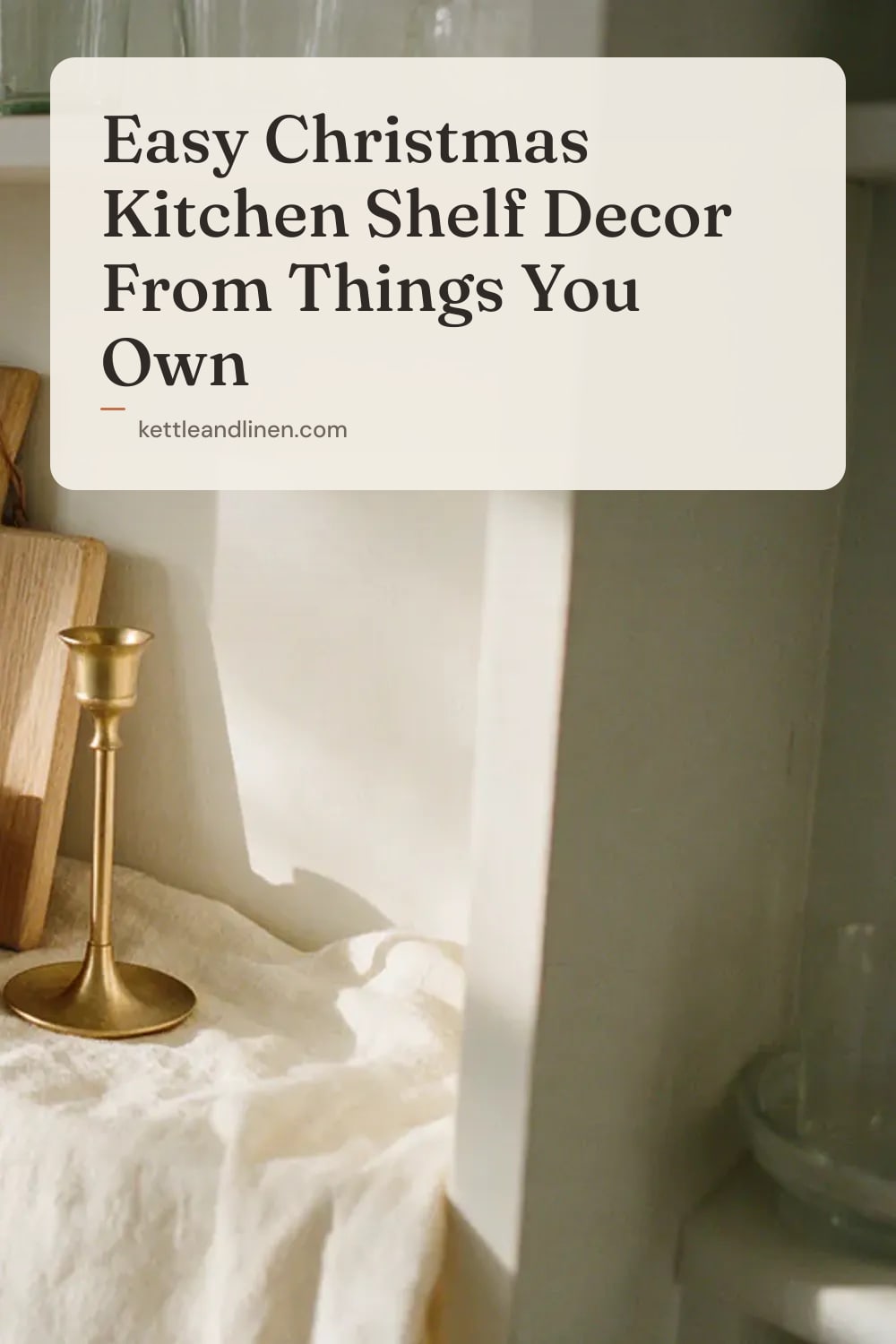 An open shelf with a wooden board, a bowl of clementines and a brass candlestick.