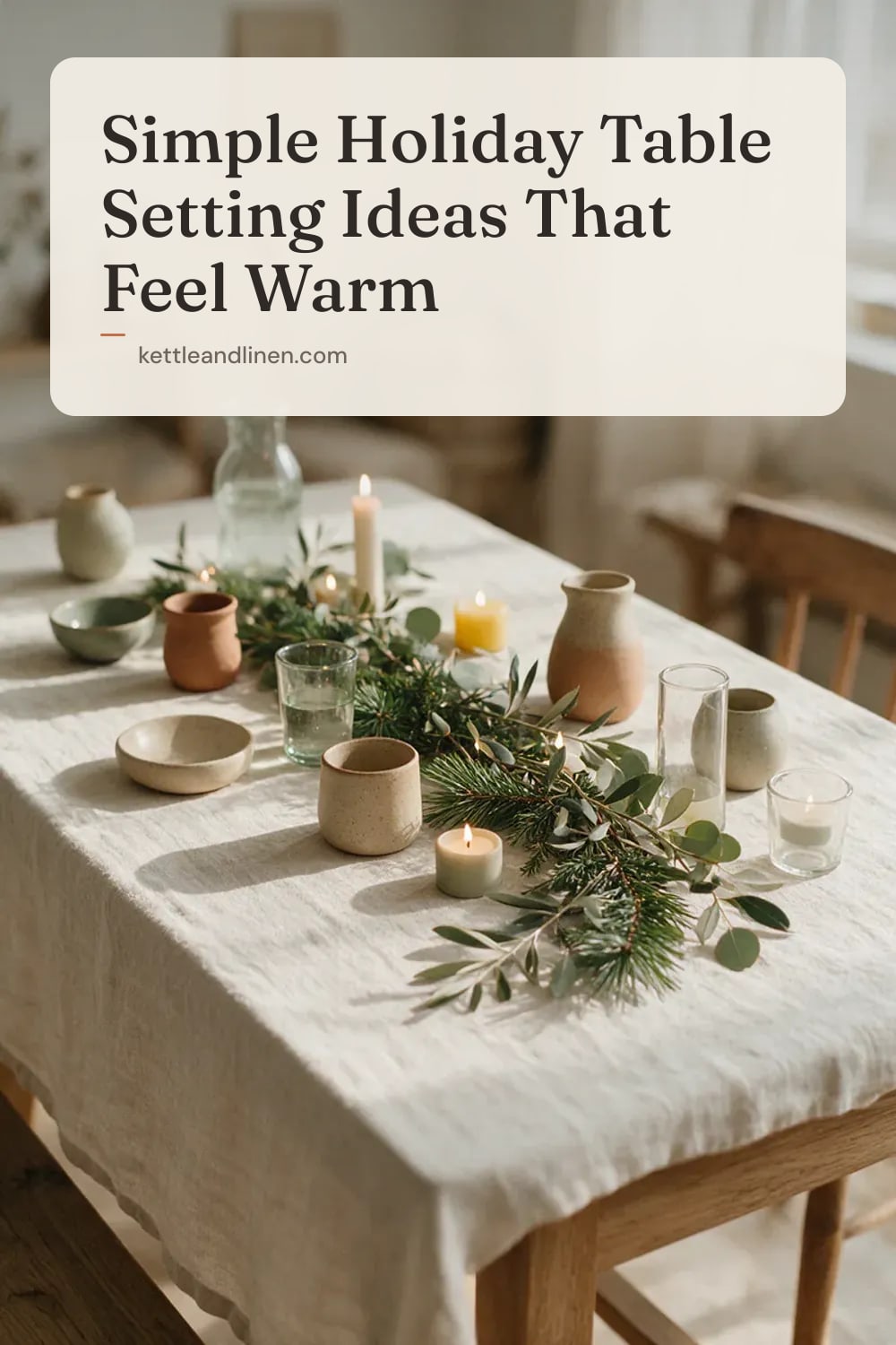 A loose garland of pine and eucalyptus down a linen-covered table with candles.