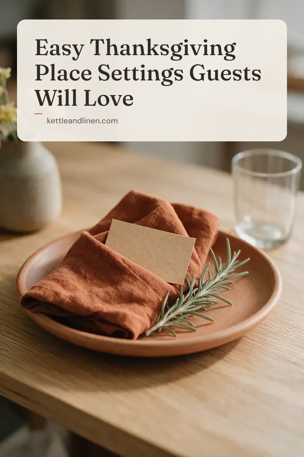 A blank kraft card tucked into a rust linen napkin with a sprig of rosemary.