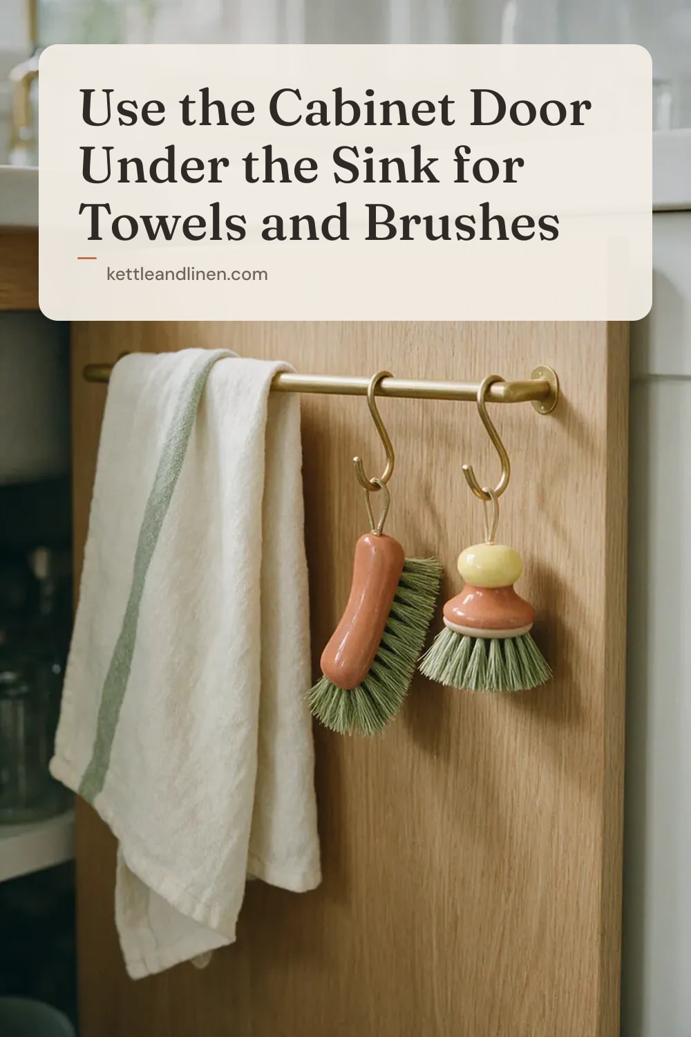 The inside of an under-sink cabinet door with a rail holding a towel and hooks with brushes.