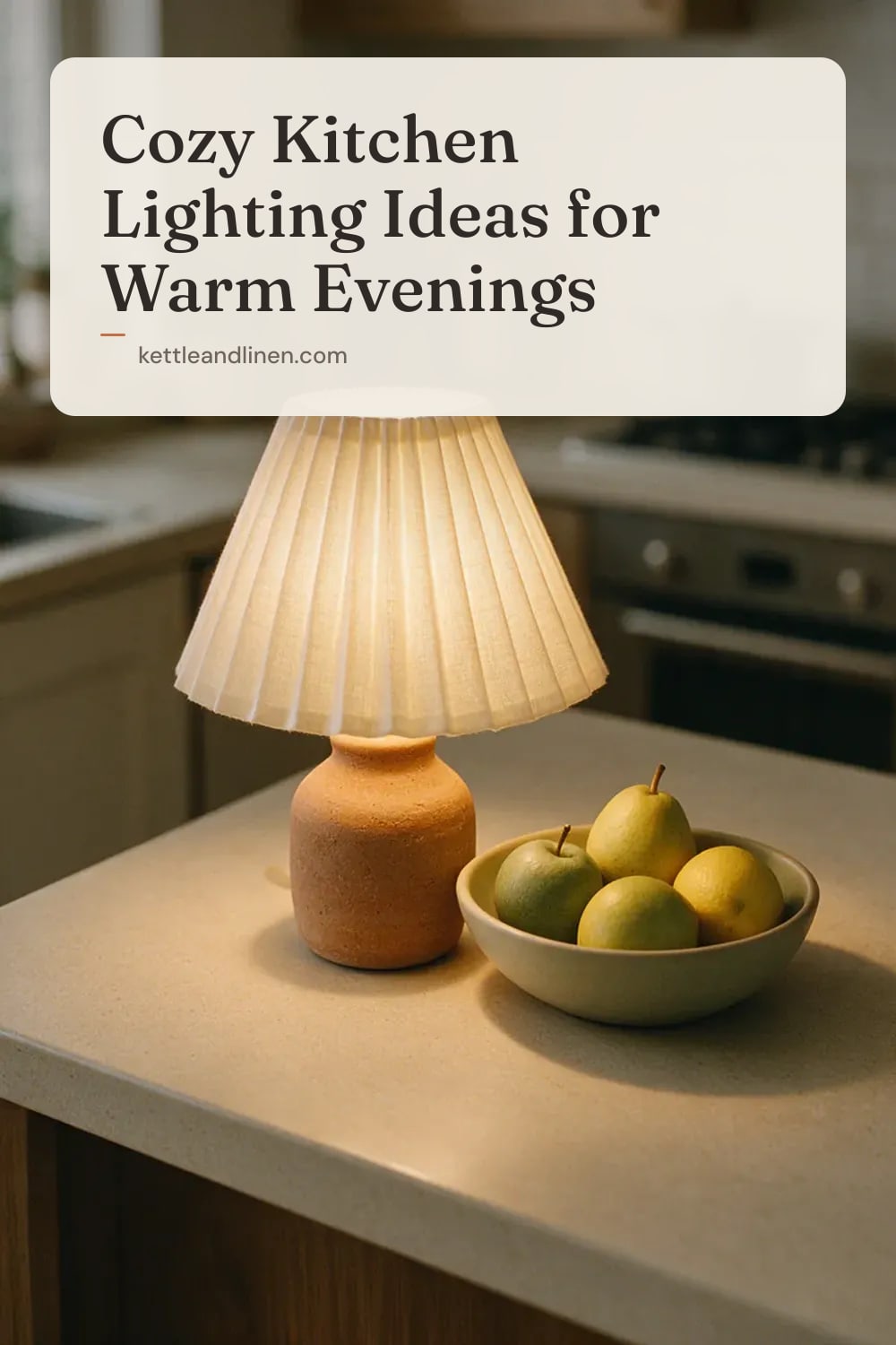 A small lamp with a linen shade glowing on a kitchen counter in the evening.