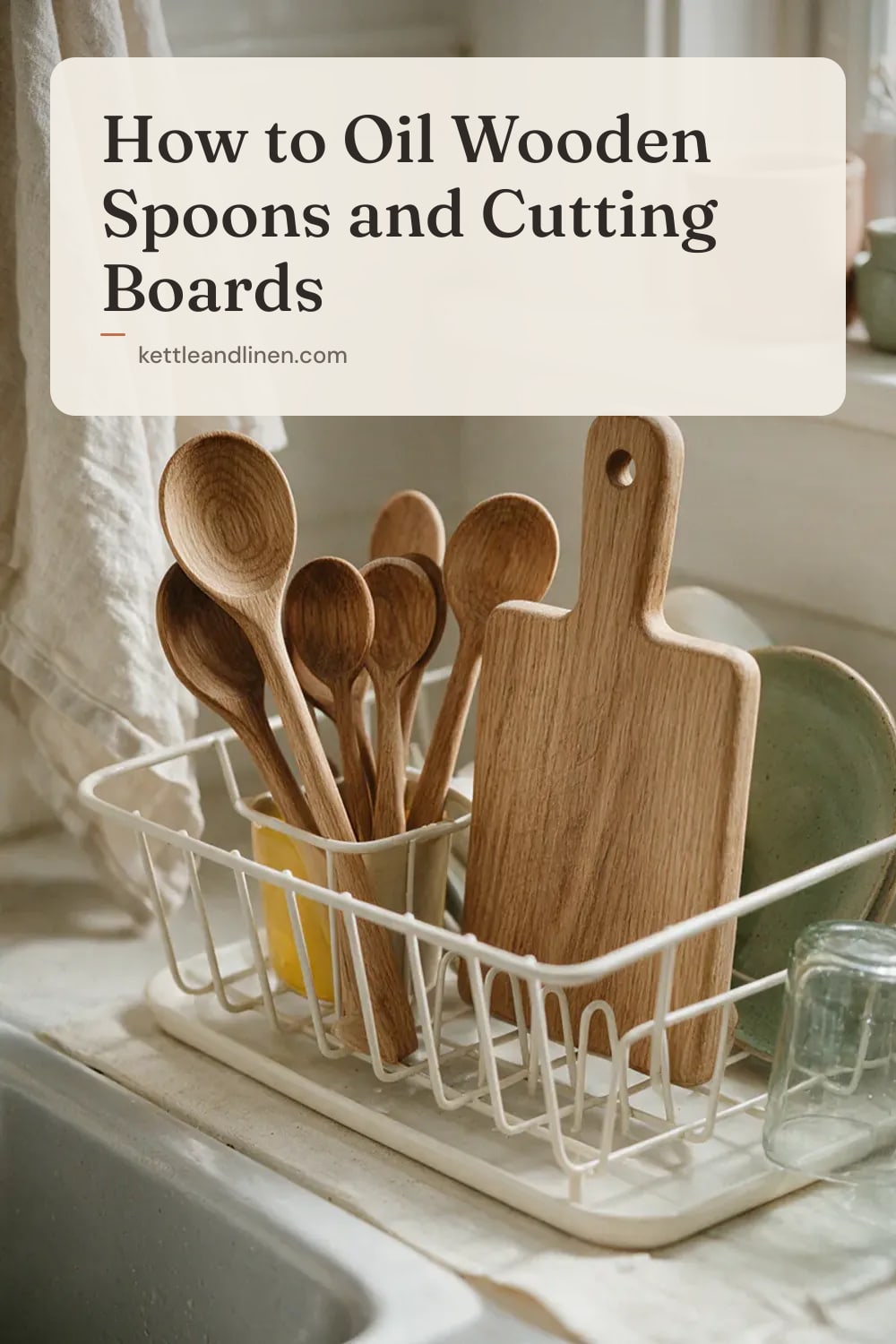 Wooden spoons and a small board drying upright in a rack beside a sink.